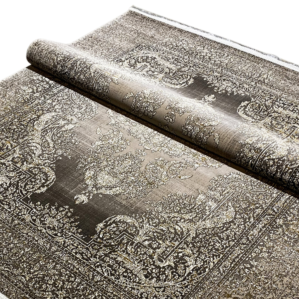 Rug with a silver-beige and dark gray paisley pattern, rolled up