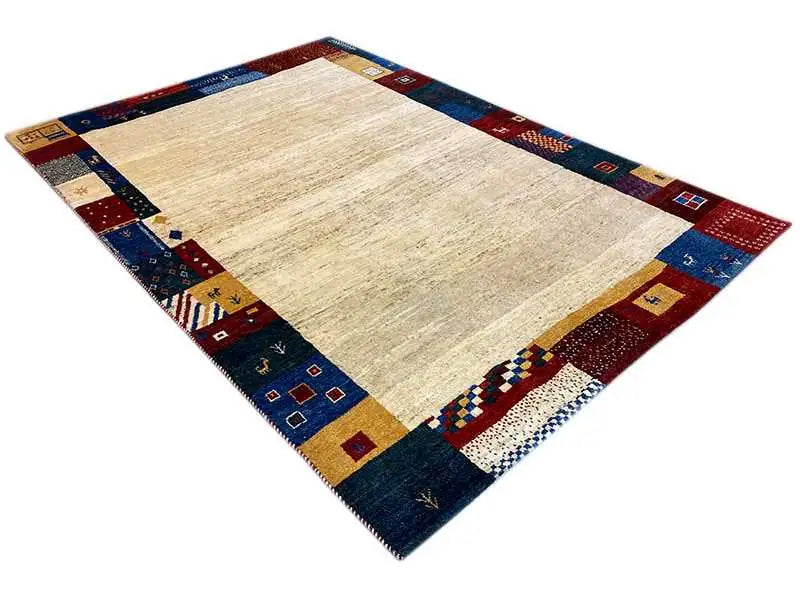Gabbeh rug diagonal: beige center, dark blue border with multicolored tiles