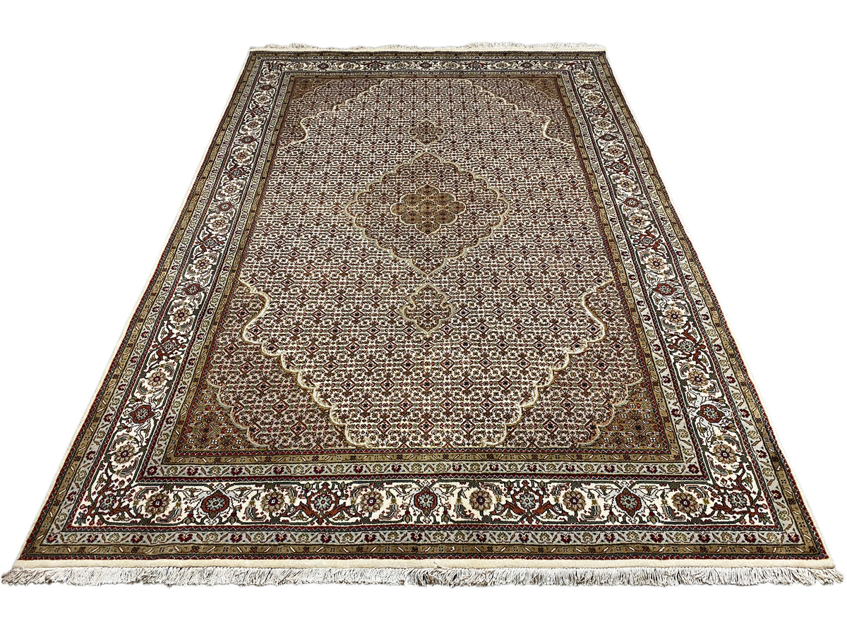 Rug laid flat, central floral motif area, and border with ornamental bands