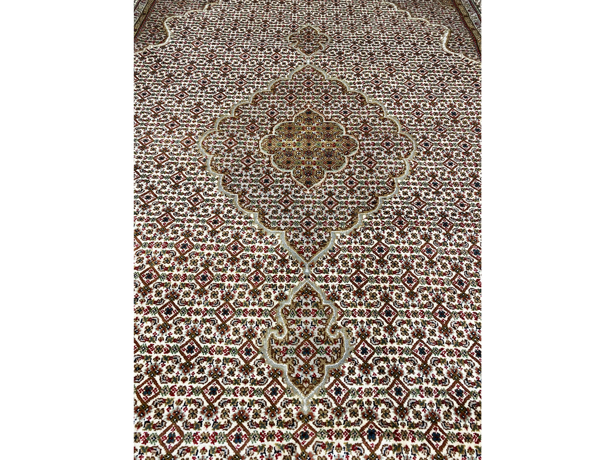Carpet detail of the medallion, fine micro-ornamental pattern in beige and dark red