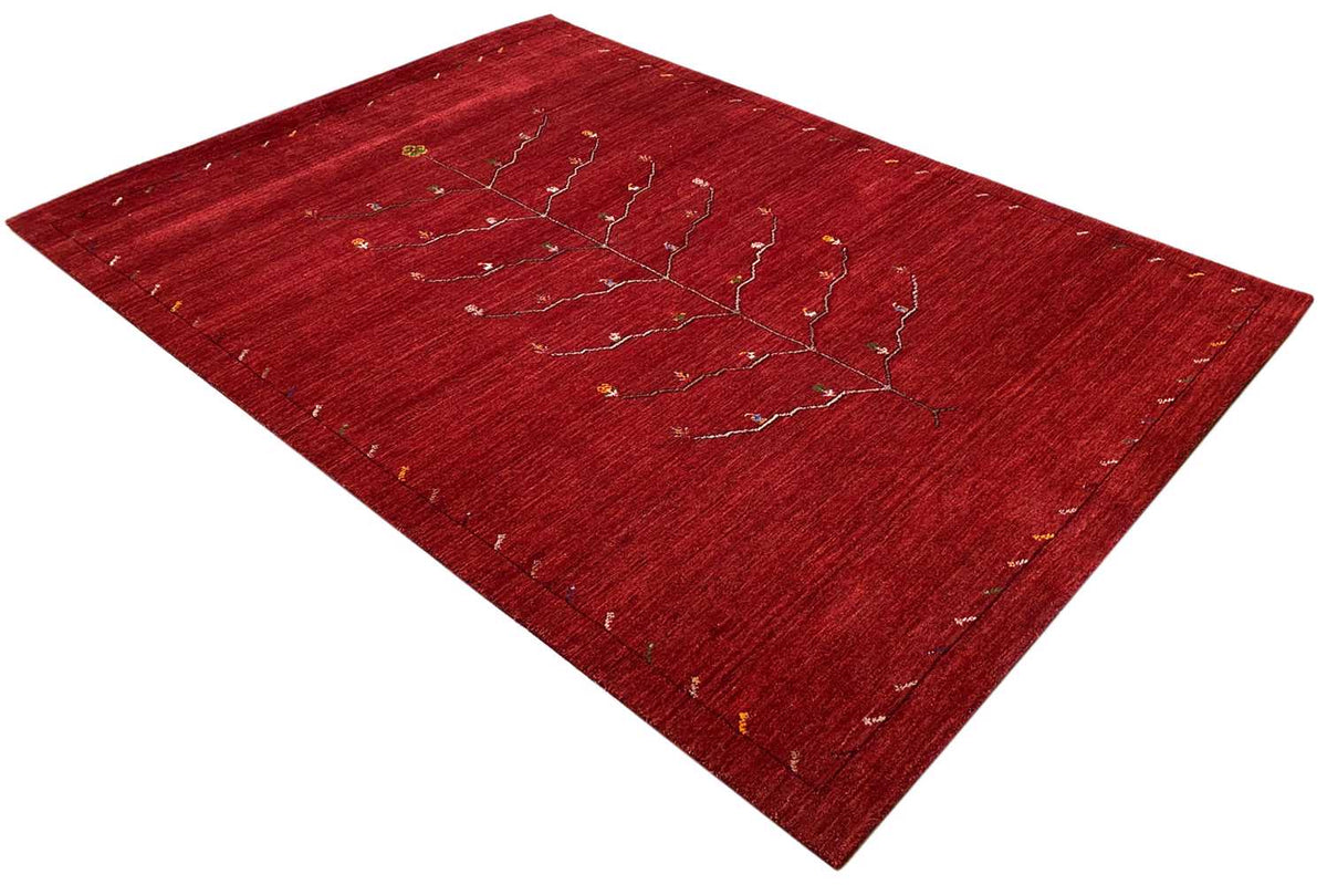Red Gabbeh rug with a linear tree-vine pattern, diagonal
