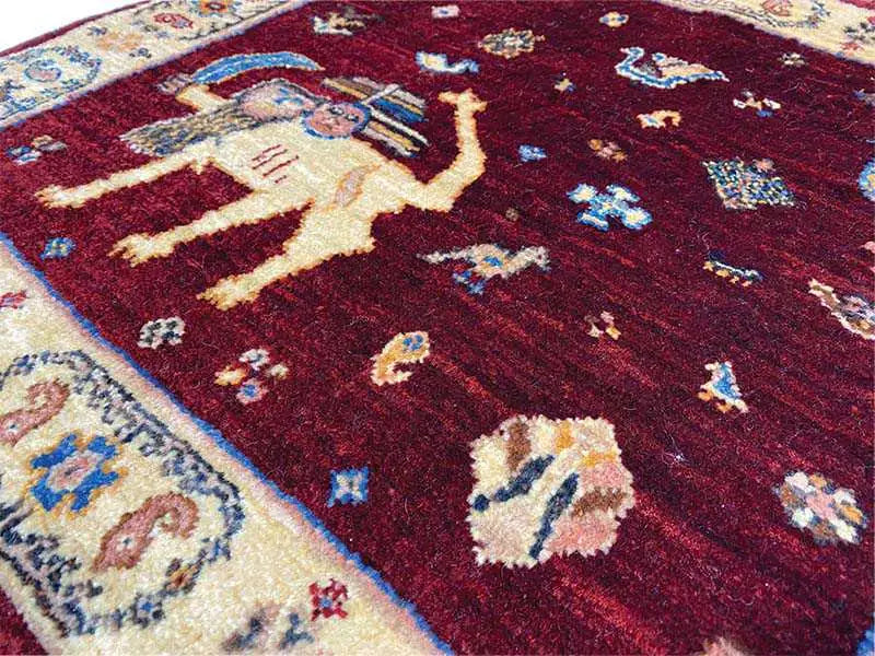 Close-up: red carpet with multicolored motifs and woven texture