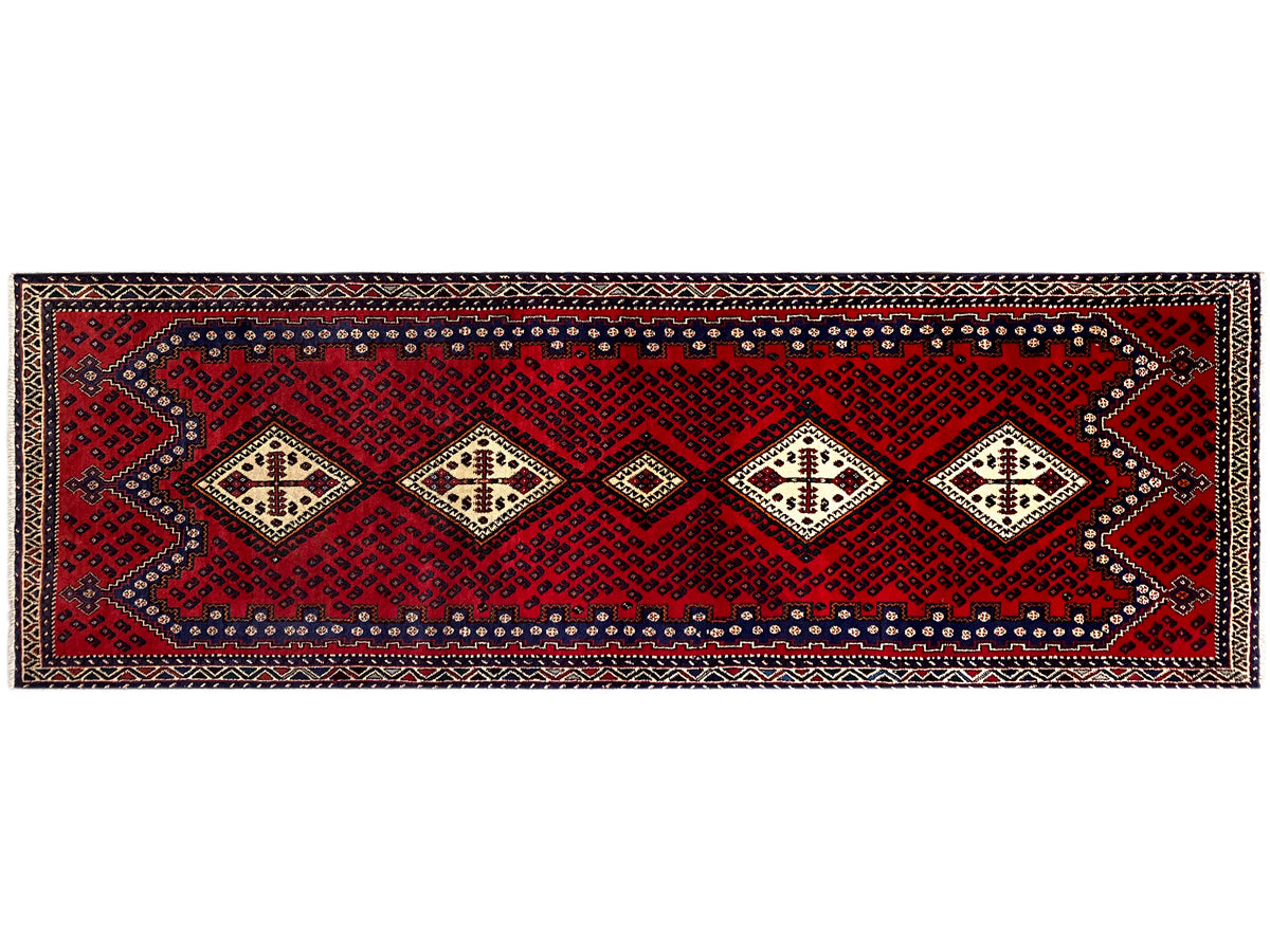 Narrow runner rug with a horizontal ornamental band and decorative borders in red and cream