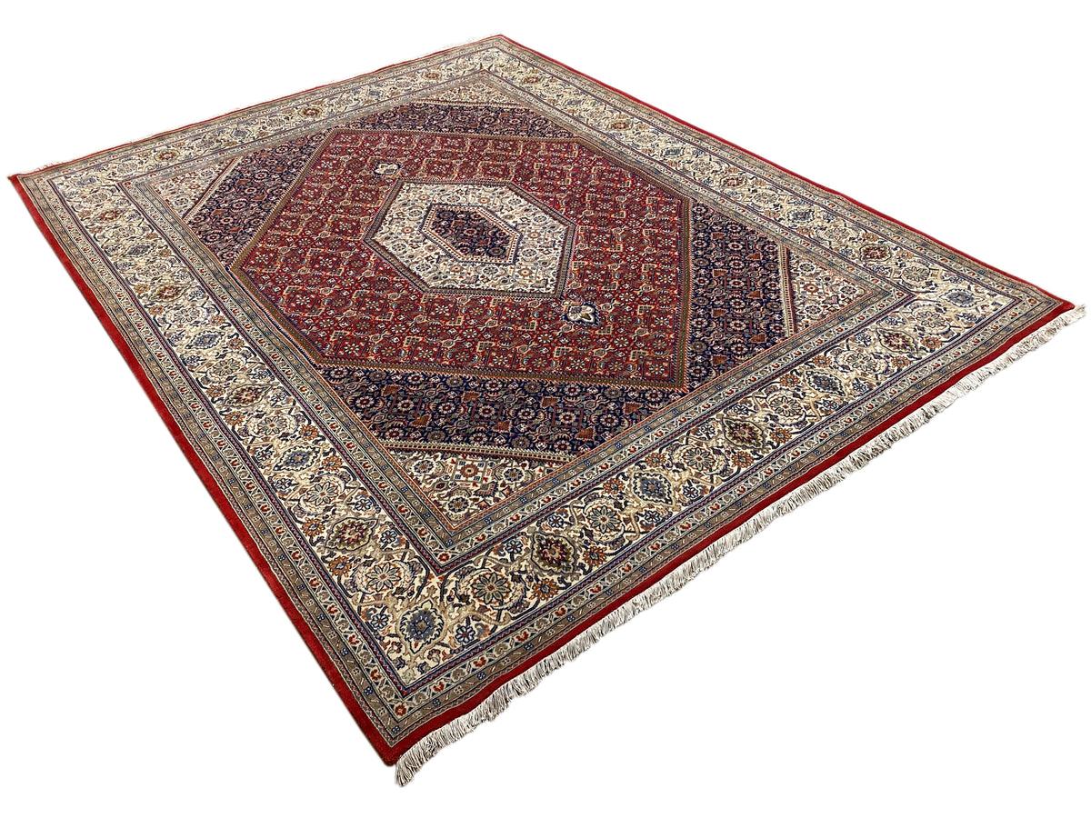 Rug with a red central motif, light decorative lines, and a wide ornamental patterned border