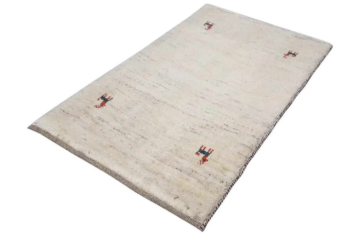 Gabbeh rug 96x60 cm: beige rug with red animal motifs, slightly angled