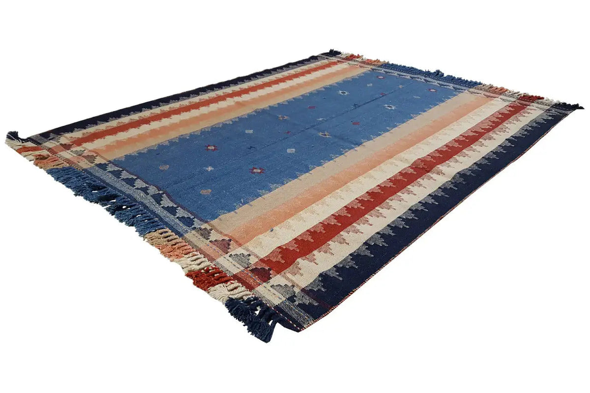 Rectangular rug in diagonal view with a blue center, striped pattern, and fringes.