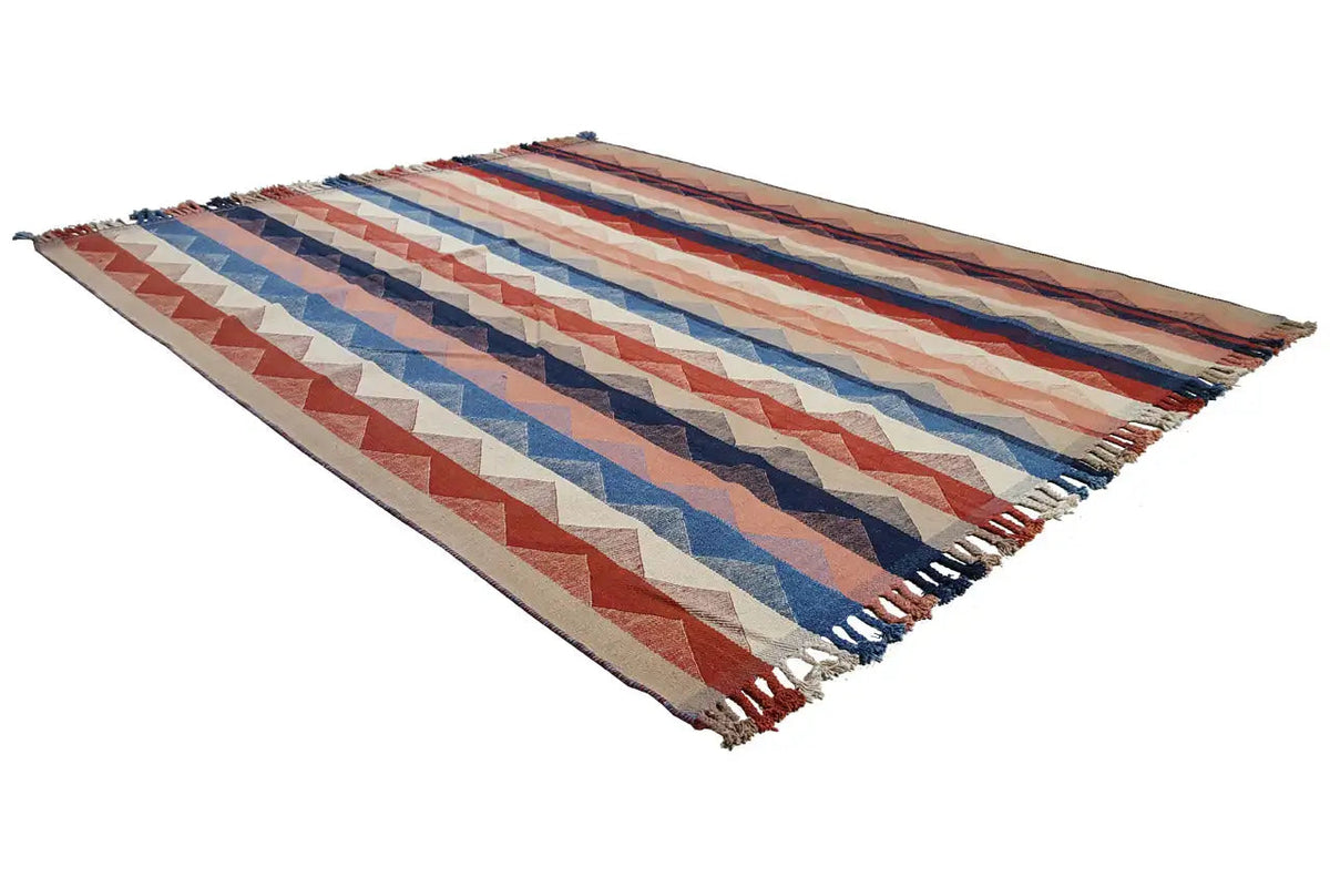 Carpet shown in three-quarter view with a striped zigzag pattern, multicolored and fringed