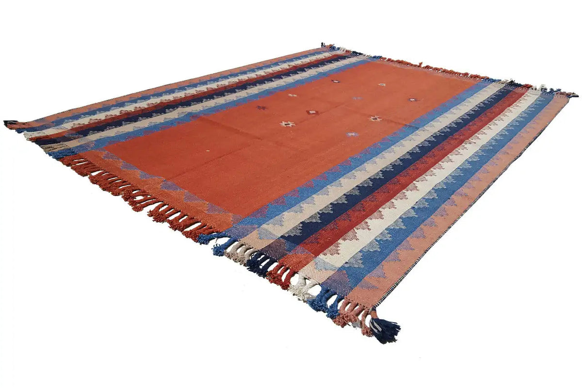 Rug diagonal: orange central section with blue stripes and fringes at the corners