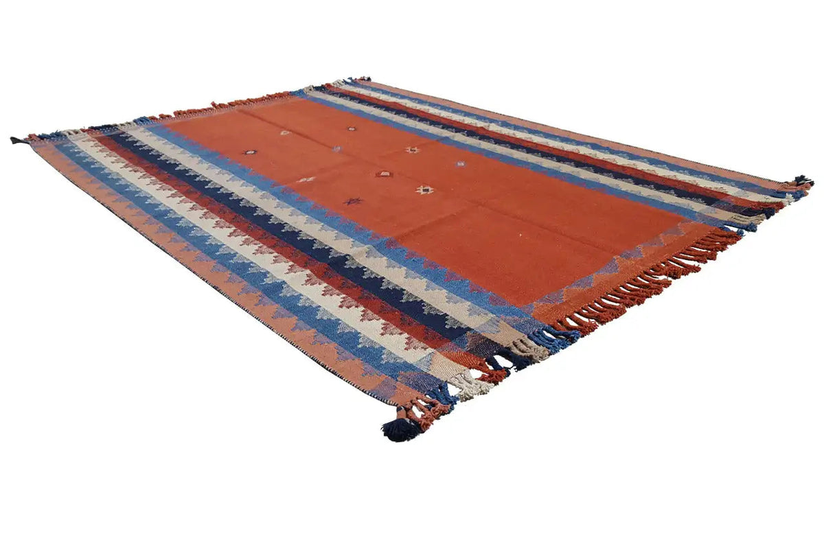 Rug spread diagonally with an orange area, blue-and-white striped sections, and fringes