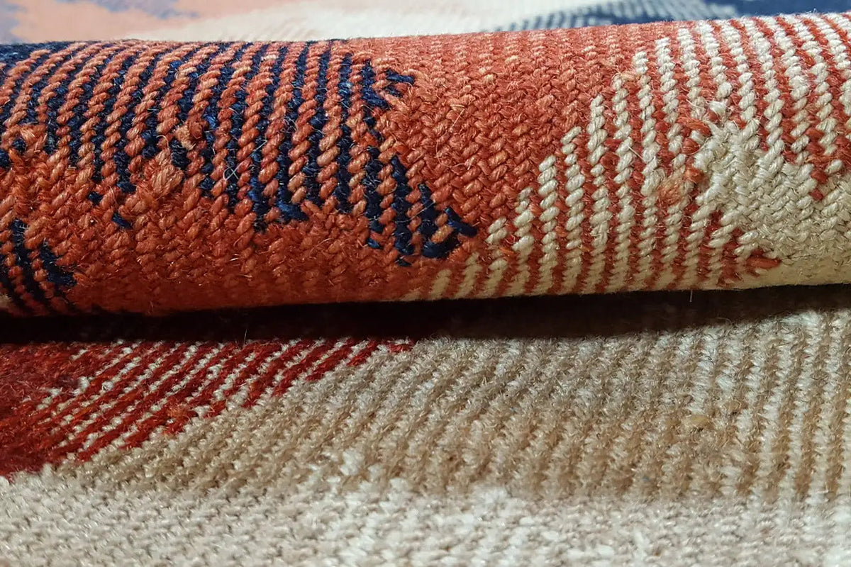 Close-up of the carpet edge: blue loops, red accents, and a beige transition