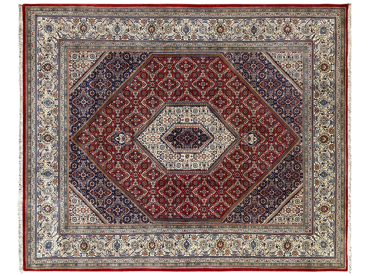 Rug with a red central field, a light medallion, and a decorative border design