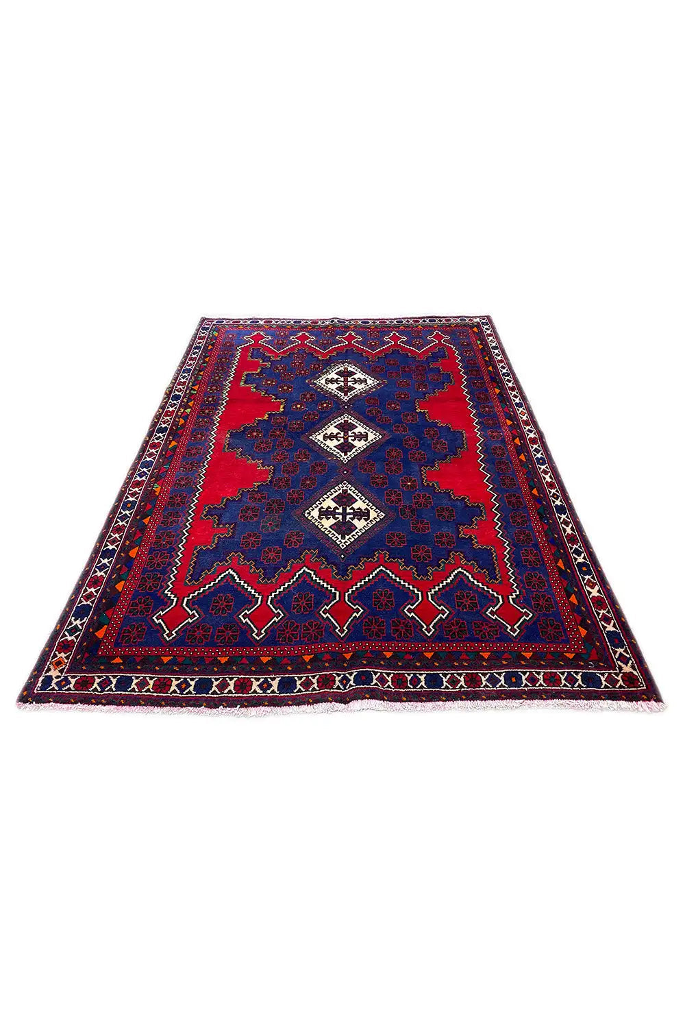 Oriental rug laid out, blue and red with borders and centered diamond motifs