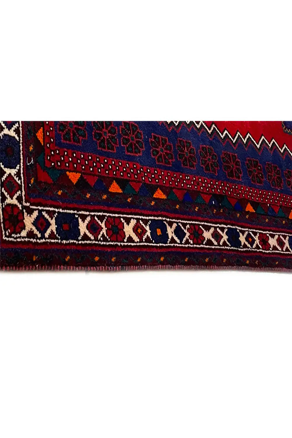Close-up of a carpet edge with a multicolored border and delicate ornamental details along the edge
