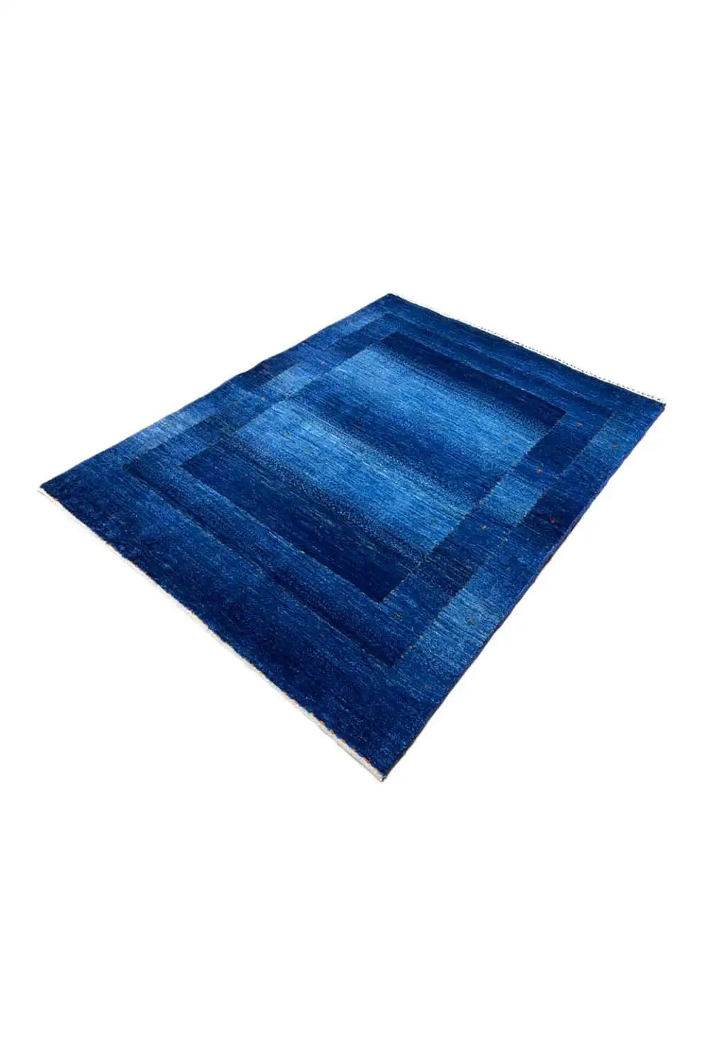 Blue Gabbeh rug with a square patchwork pattern, laid diagonally