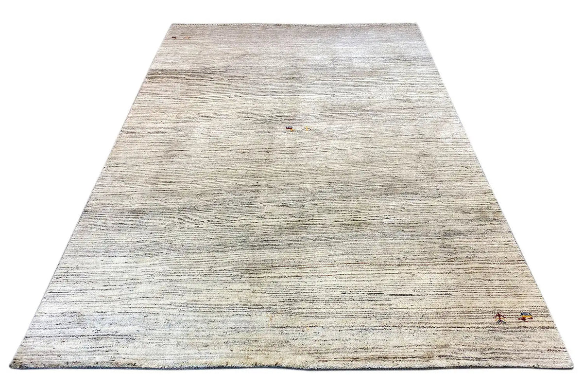 Rug in an A-line view with a light, woven textured pattern and small pops of color