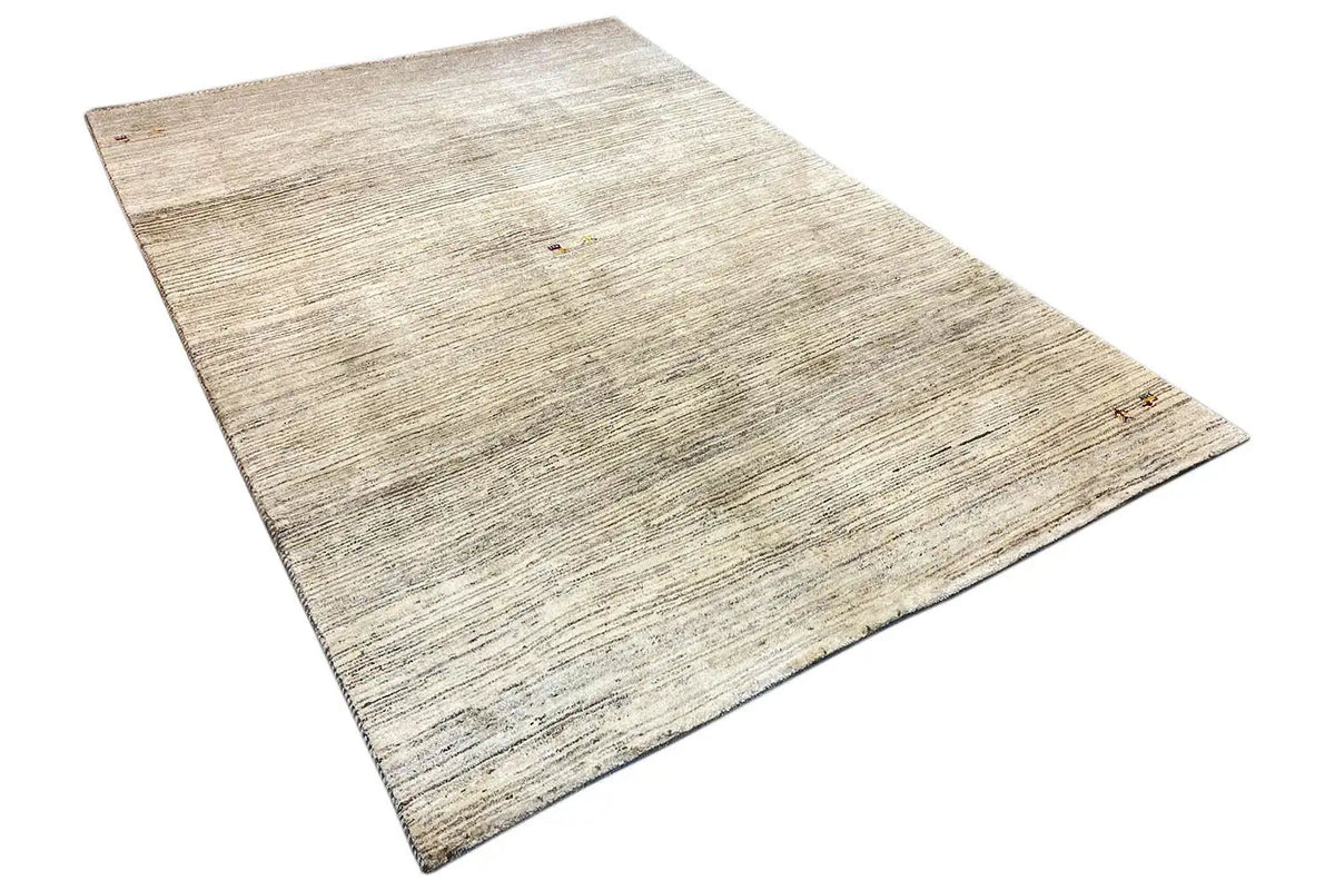 Carpet made from light-colored yarn with a fine, mottled texture and subtle dark stripes