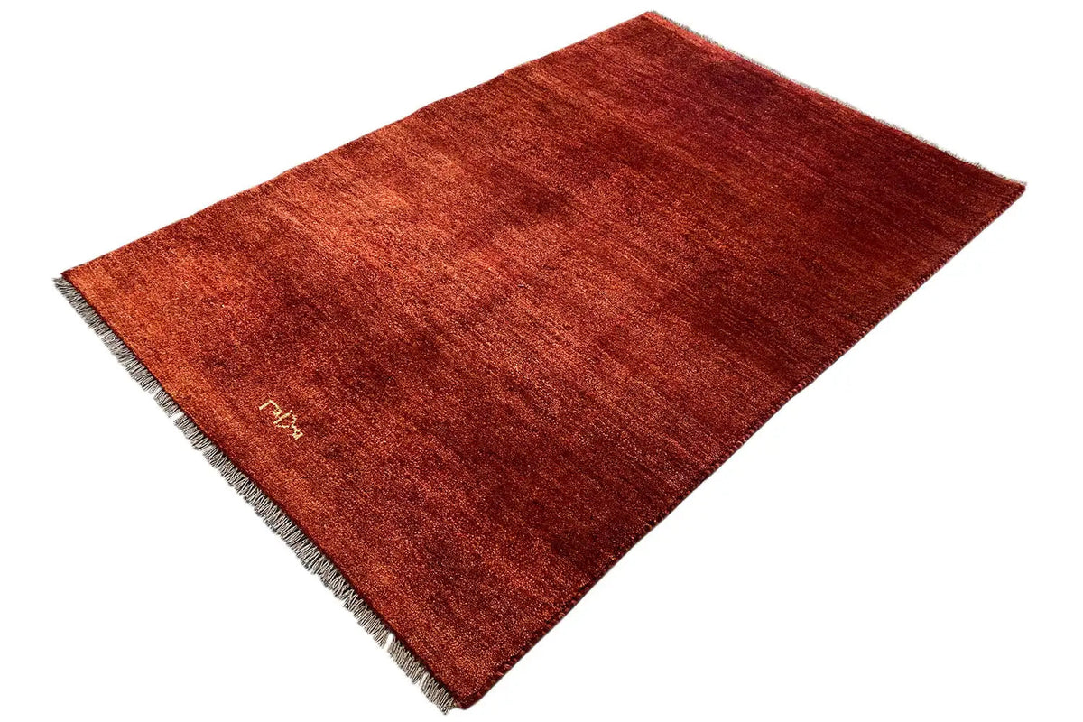 Reddish-brown Gabbeh rug, short pile, fringes, subtle linear texture