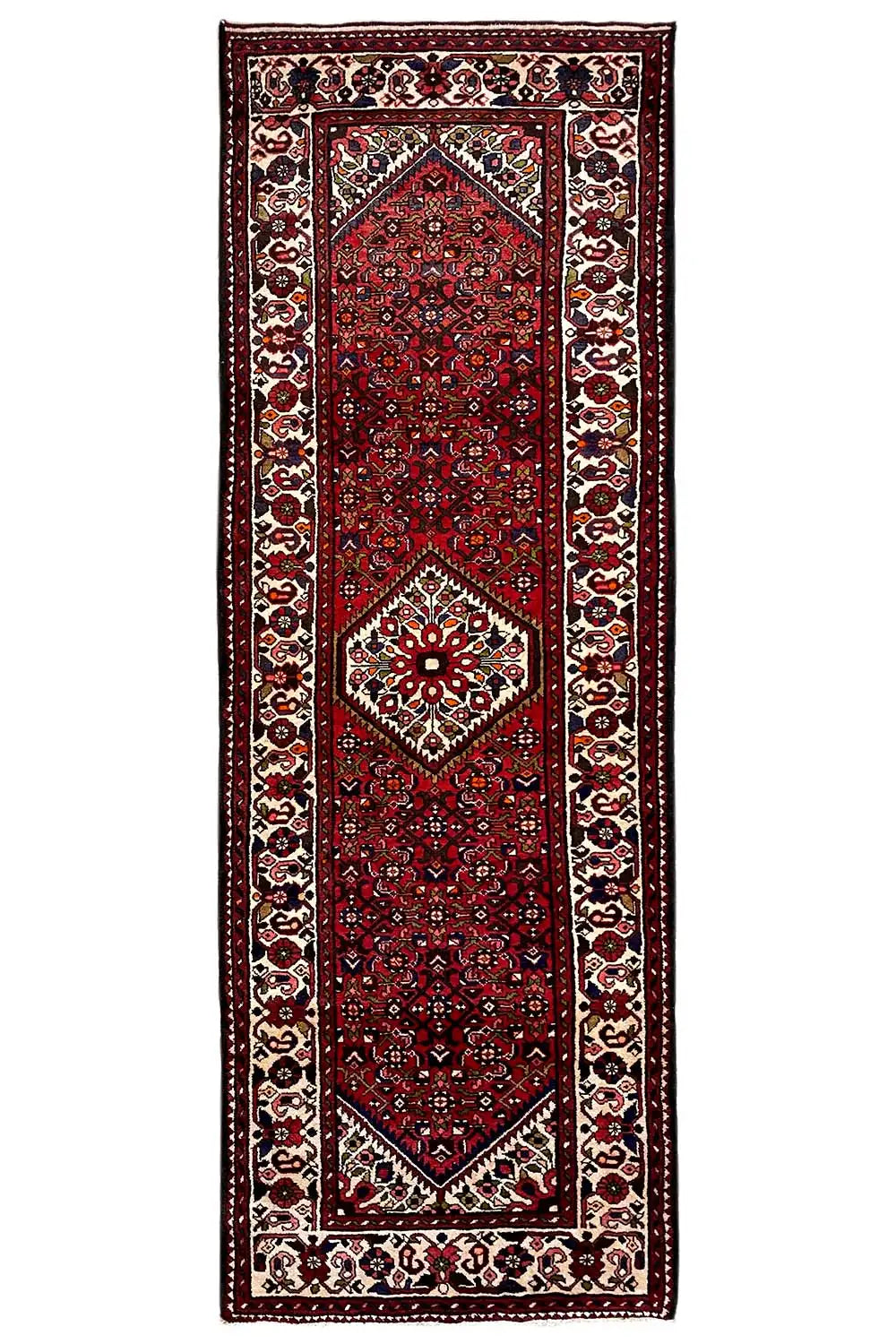 Narrow red runner with a central medallion and richly decorated corner ornaments