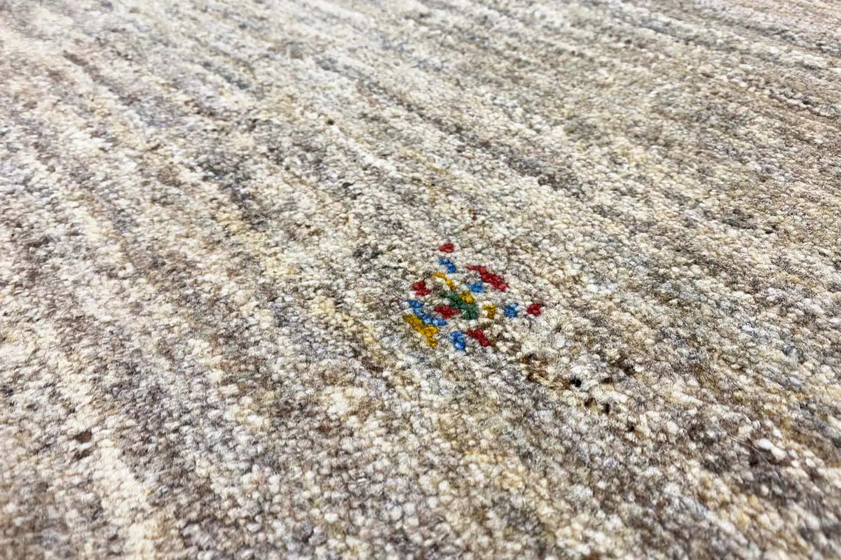 Gabbeh rug with a beige pile and multicolored decorative motif