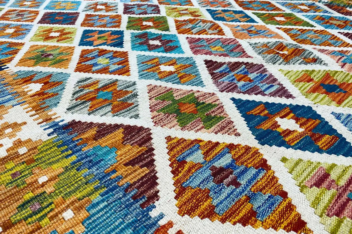 Afghan kilim with a colorful geometric pattern, close-up of the woven texture