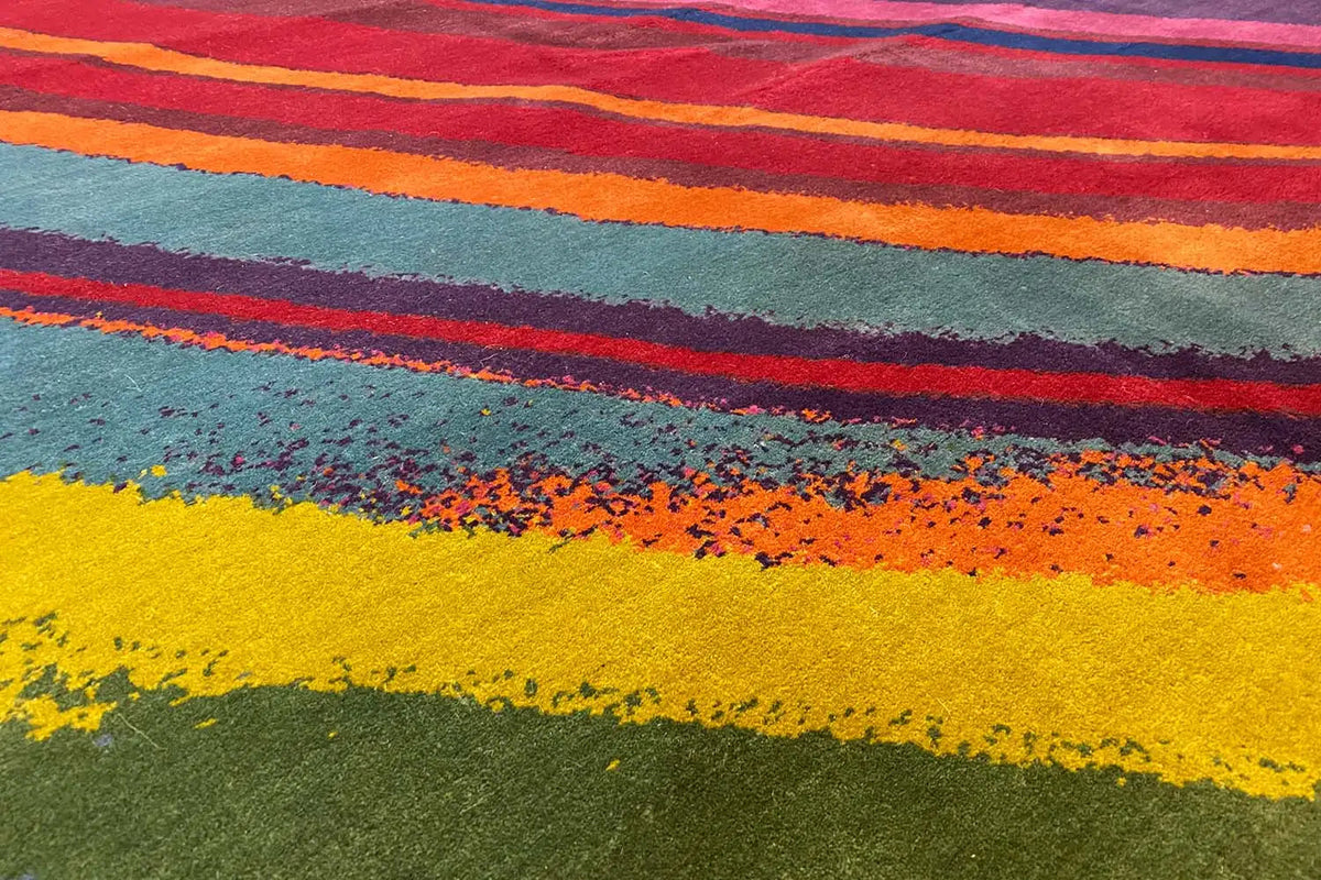 Close-up of the carpet surface: orange, yellow, and blue bands of color