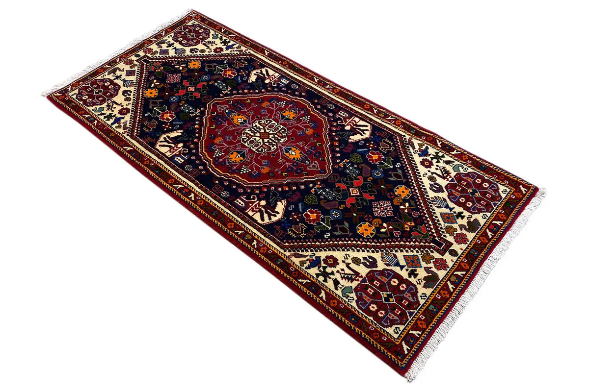 Oriental rug with a dark medallion, red center, and multicolored borders