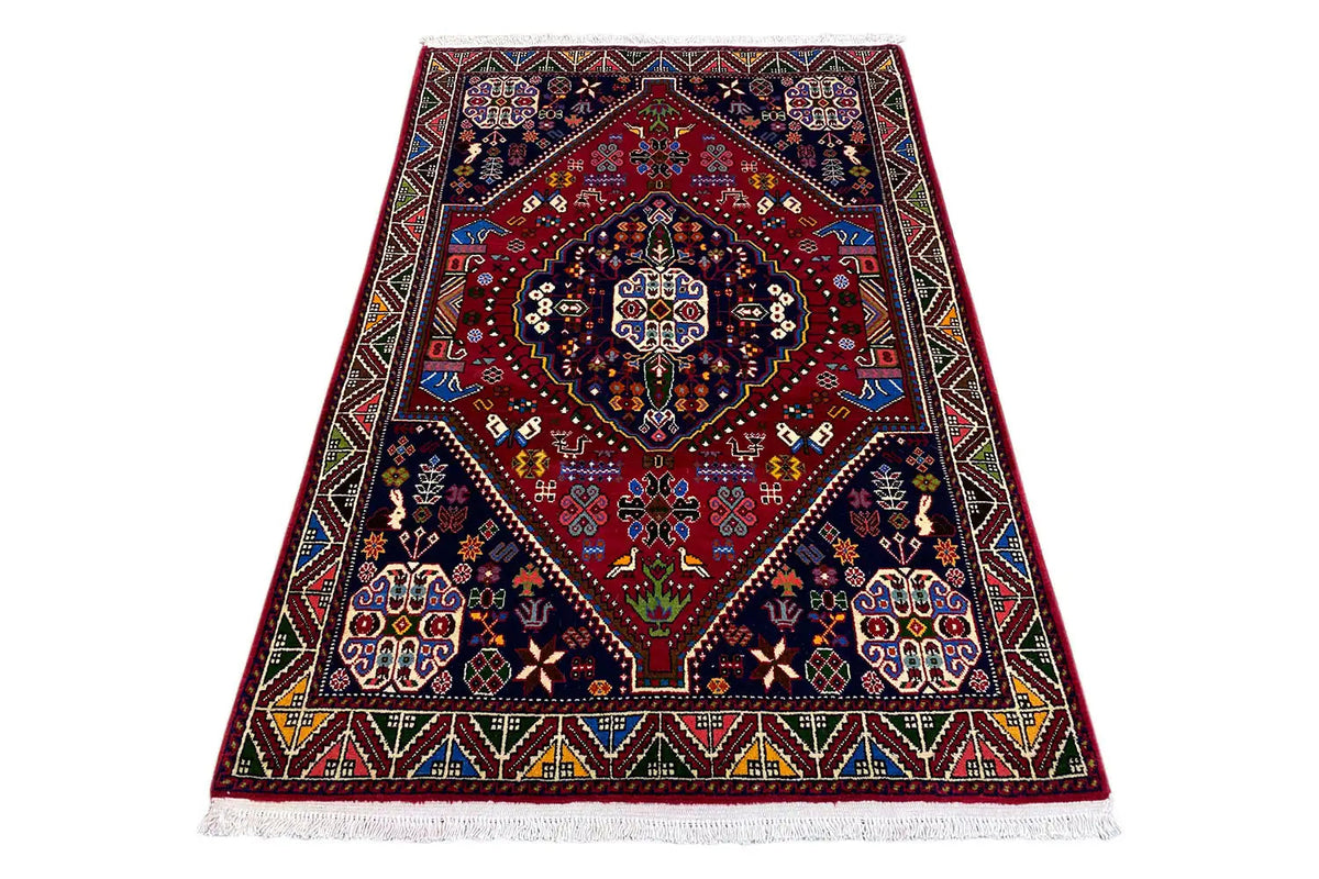 Oriental rug with a red center and dark blue ornaments, with a colorful edge border