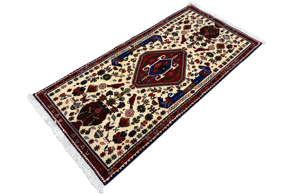 Oriental rug, cream-colored pattern with a blue-red border, fringes, elongated view