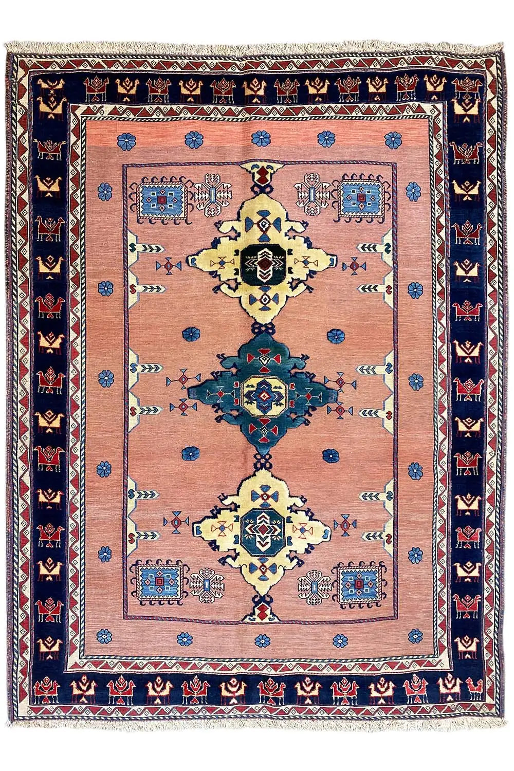 Oriental rug with a symmetrical medallion in pink, blue, yellow, and dark blue areas