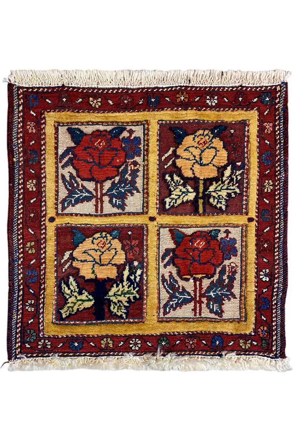 Square rug with four floral panels, red border, and fringe, 48x42 cm