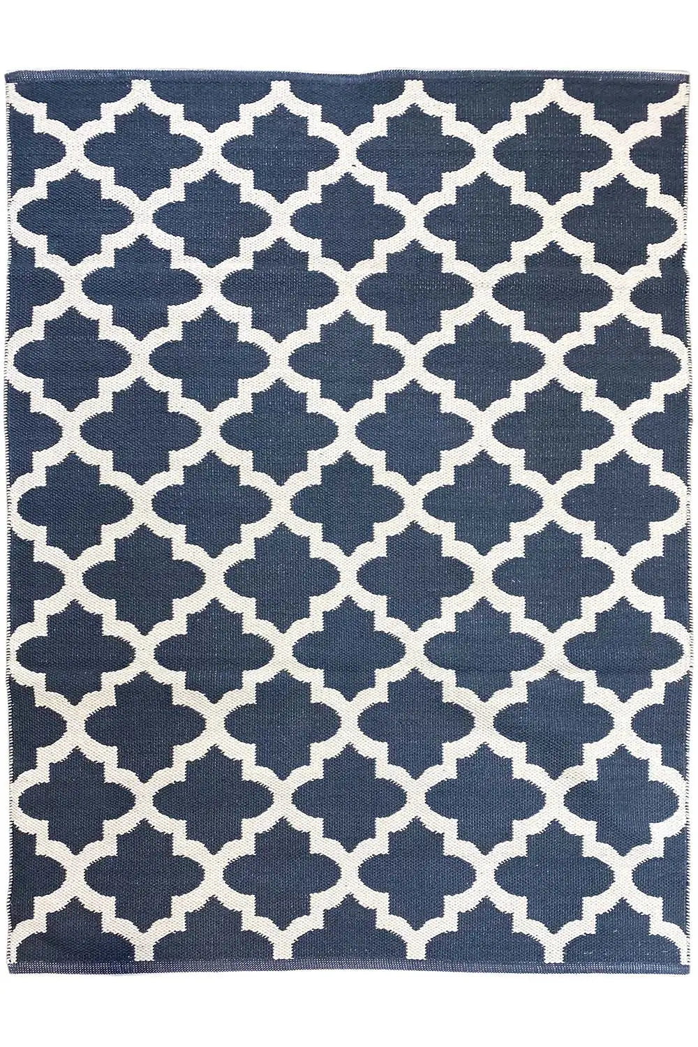 Rectangular kilim rug with a dark blue background and white quatrefoil diamond pattern
