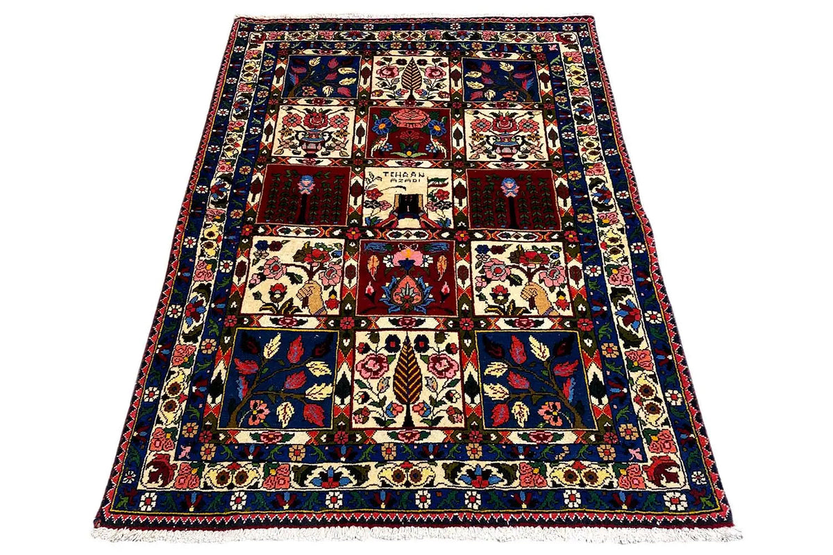 Rectangular rug with a dark background and beige and red tile pattern.