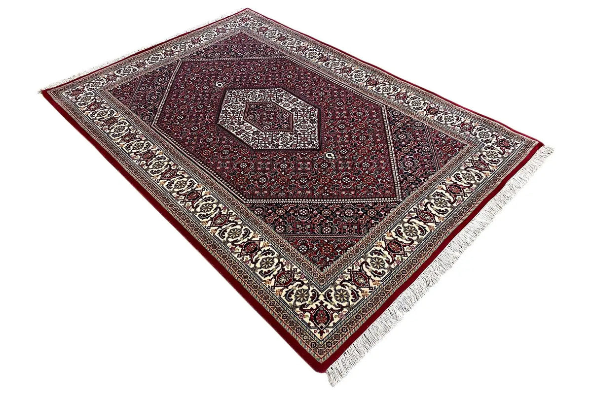 Bidjar rug (185x124 cm) – lying at an angle, dark red with gray-blue diamonds and border