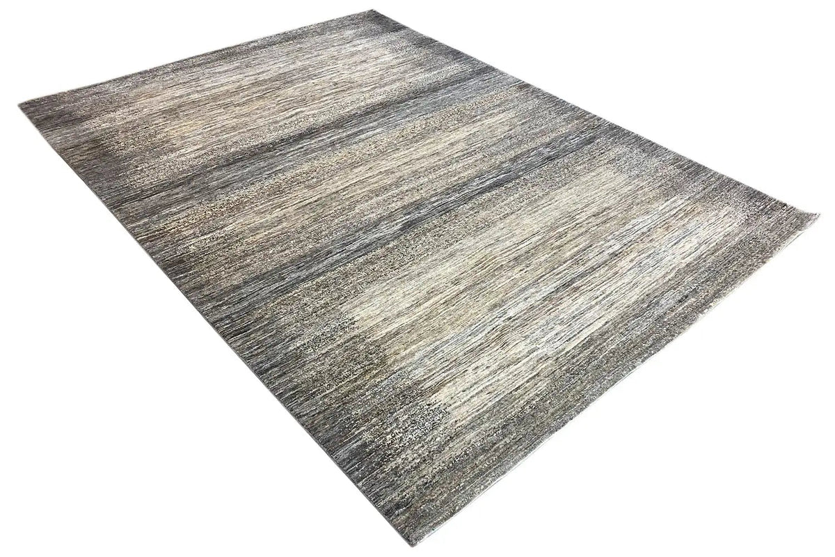 Gabbeh Lori rug draped diagonally; woven pattern in gray, beige, and dark gray
