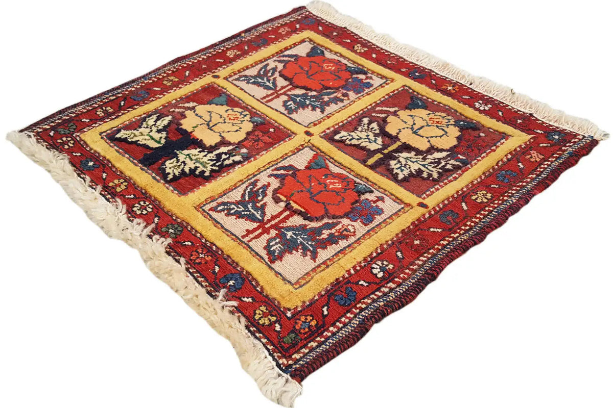 Woven rug with square floral motifs, red border, and fringes, 48x42 cm