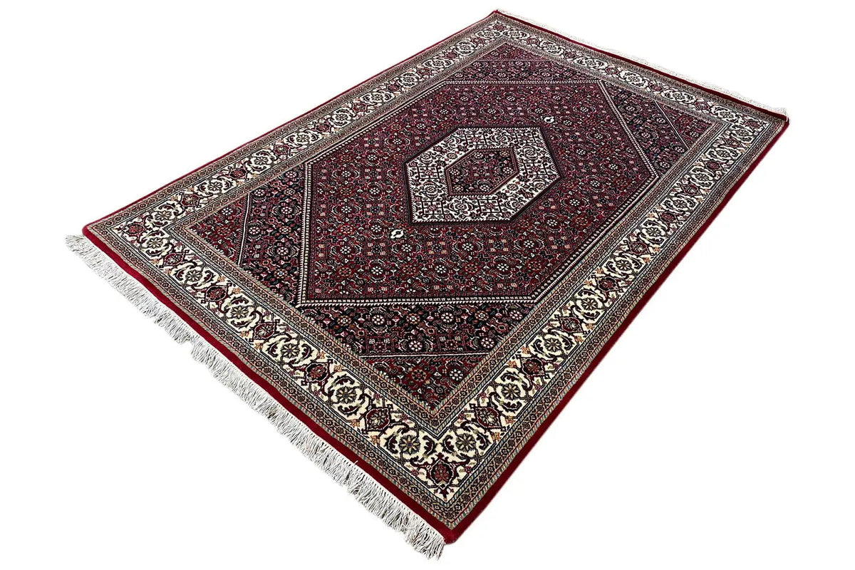 Bidjar rug, diagonal, with fringes, a red background, and light ornamental borders