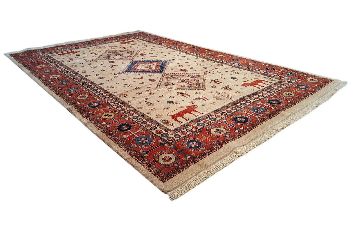 Qashqai exclusive rug, oblique view: red border, cream field with blue central motif