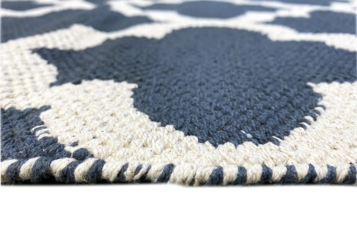 Kilim rug edge detail with a visible woven pattern and short fringes