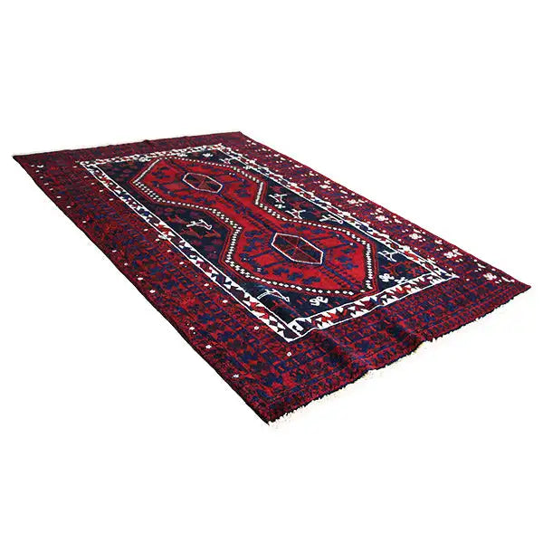 Oriental rug in burgundy, blue and dark red with a geometric medallion and border