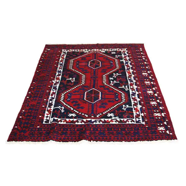 Oriental rug with a central medallion, red pattern, and dark border with decorative stripes