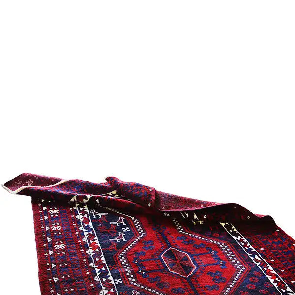 Oriental rug, partially rolled up: red field with a blue medallion and white decorative lines