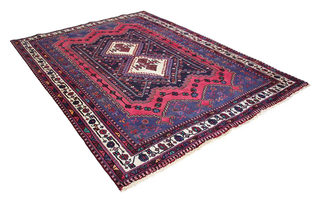 Sirjan rug, diagonal view, blue-red with a medallion in the center and decorative borders