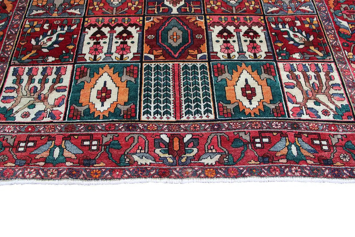 Oriental rug detail: multicolored border and ornamental panels along the edge, 315×220 cm