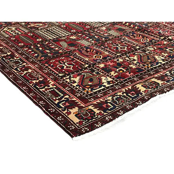 Oriental Bakhtiari rug detail view: colorful medallions, diamonds, and borders in dark red