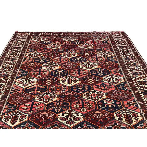 Persian rug with dense geometric ornament, dark red, blue, beige