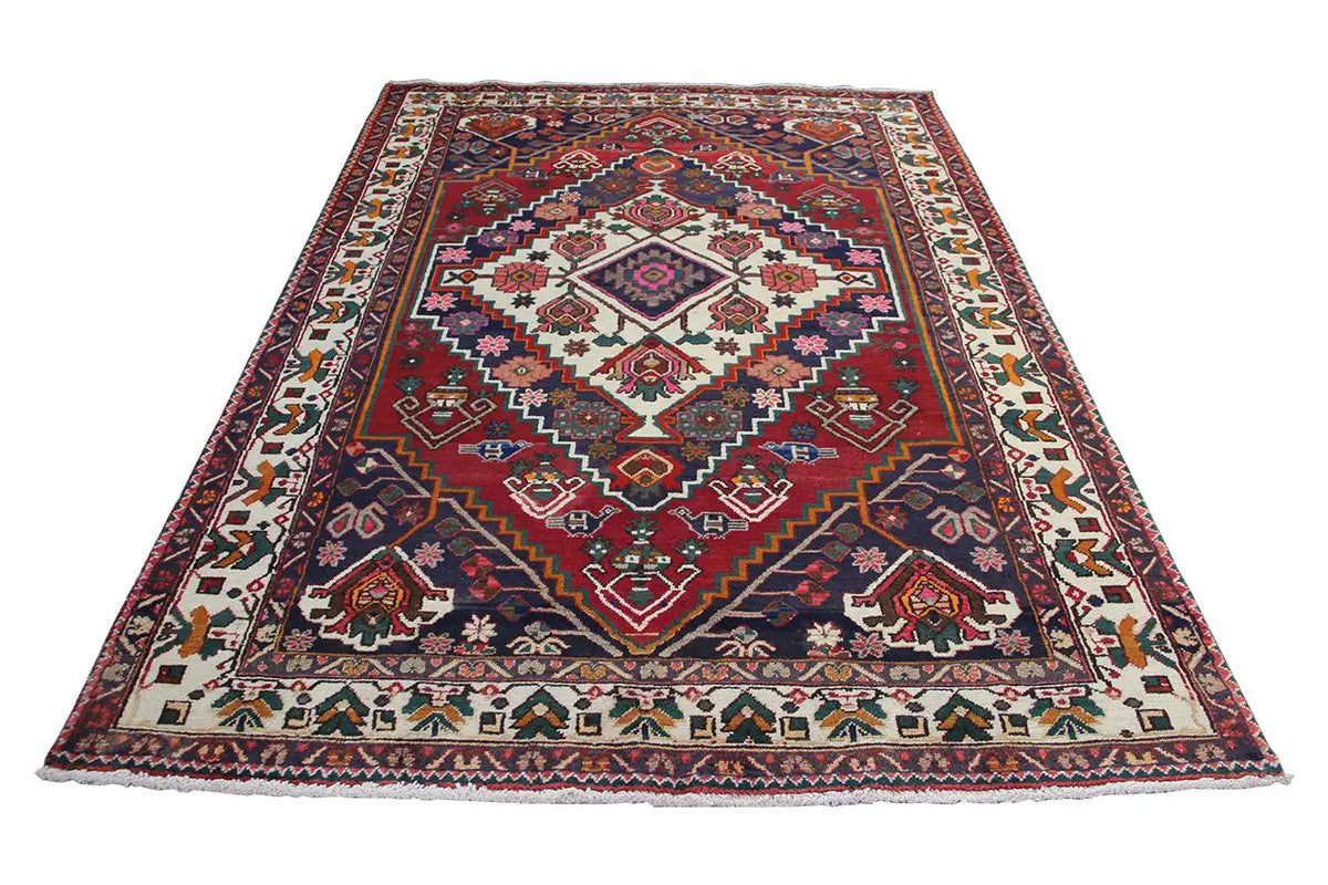 Oriental rug, lying flat, red ground motif with a blue border and ornamental friezes