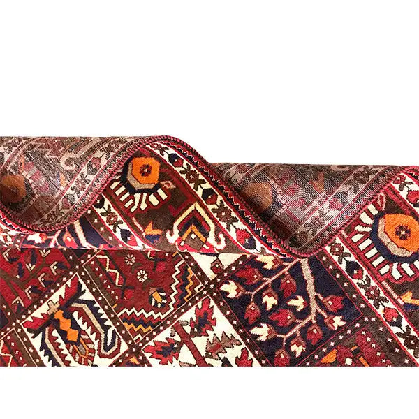 Bakhtiari rug with a burgundy field and geometric pattern, surrounded by a border
