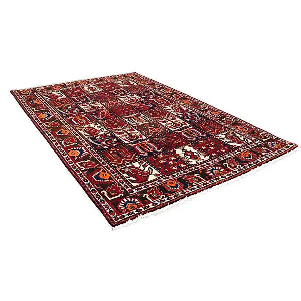 Bakhtiari rug lying flat, an overall burgundy-red appearance with contrasting geometric rows