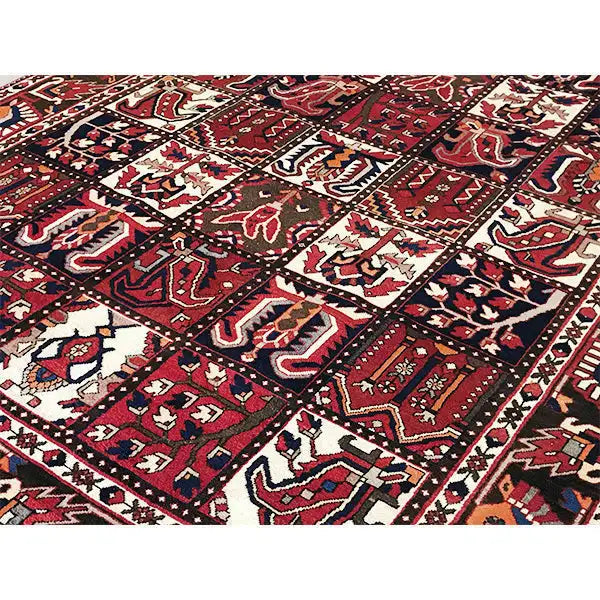 Bakhtiari rug close-up of the surface: geometric motifs in burgundy, cream, and dark blue