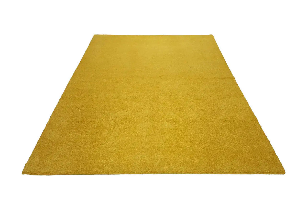 Mustard-yellow Gabbeh rug, spread out in perspective